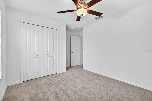 36618 Garden Wall Way, Zephyrhills, FL 33541 - unfurnished bedroom with carpet flooring, a closet, and a ceiling fan