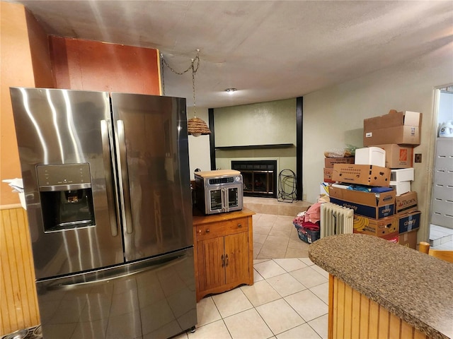 5221 82nd Ave N, Pinellas Park, FL 33781 - kitchen featuring stainless steel refrigerator with ice dispenser, a tiled fireplace, light tile patterned flooring, and open floor plan