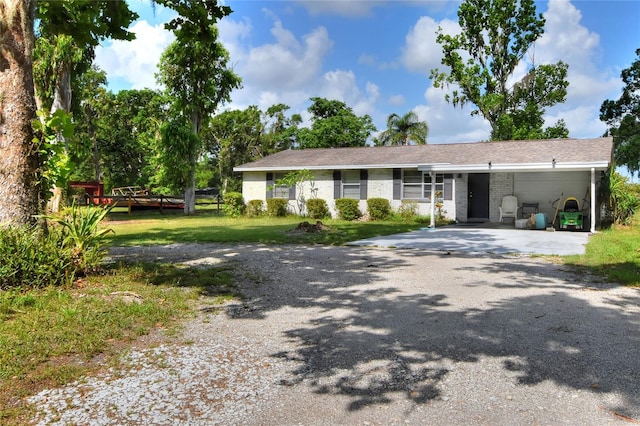 12631 Hobson Simmons Rd, Lithia, FL 33547 - ranch-style home with asphalt driveway, a carport, and brick siding