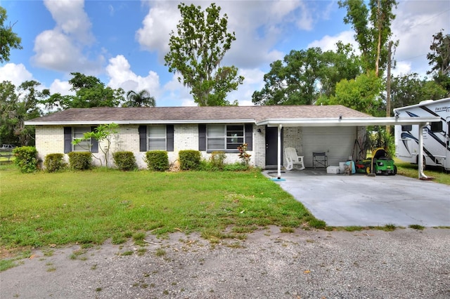 12631 Hobson Simmons Rd, Lithia, FL 33547 - ranch-style home with a garage, brick siding, a front yard, and driveway