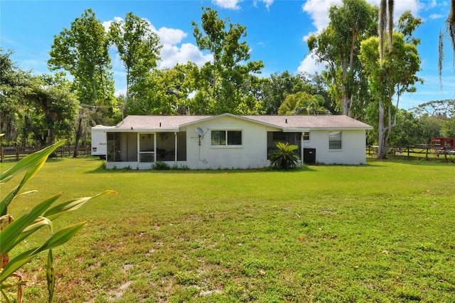 12631 Hobson Simmons Rd, Lithia, FL 33547 - back of house featuring a sunroom and view of wooded area