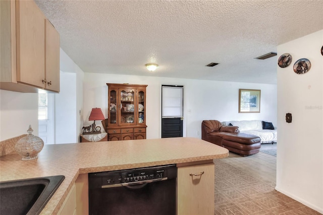 12631 Hobson Simmons Rd, Lithia, FL 33547 - kitchen with black dishwasher, a peninsula, open floor plan, a textured ceiling, and light countertops
