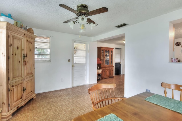 12631 Hobson Simmons Rd, Lithia, FL 33547 - dining space with a ceiling fan, a textured ceiling, and light flooring