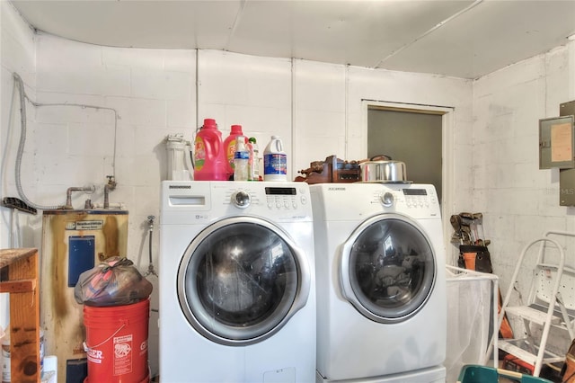 12631 Hobson Simmons Rd, Lithia, FL 33547 - laundry room with washer and clothes dryer, concrete block wall, and water heater