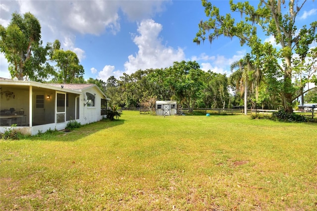 12631 Hobson Simmons Rd, Lithia, FL 33547 - view of yard featuring a shed, a sunroom, and view of scattered trees