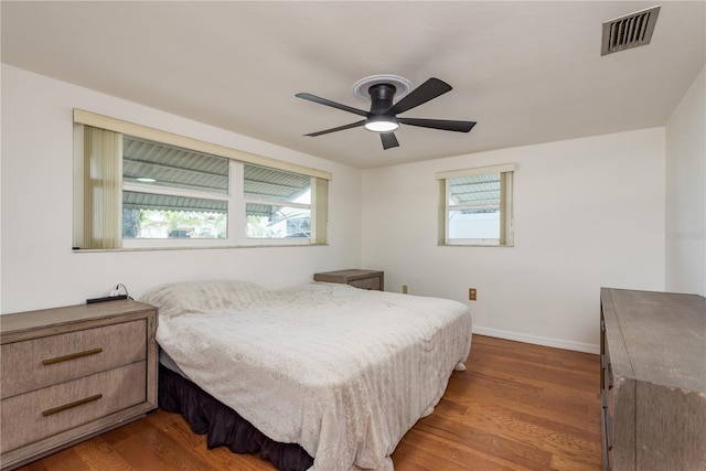 3547 Morley Dr, New Port Richey, FL 34652 - bedroom with multiple windows, dark wood-style flooring, and a ceiling fan