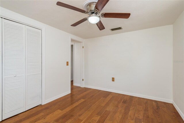 3547 Morley Dr, New Port Richey, FL 34652 - unfurnished bedroom featuring a closet, wood finished floors, and a ceiling fan
