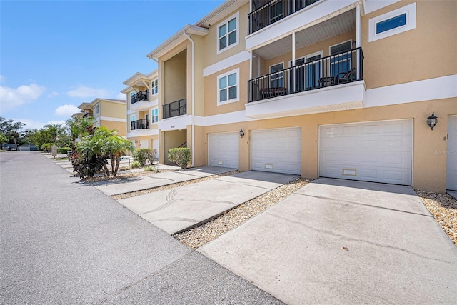 5065 Royal Palms Way Unit 303, New Port Richey, FL 34652 - view of building exterior featuring a garage and driveway
