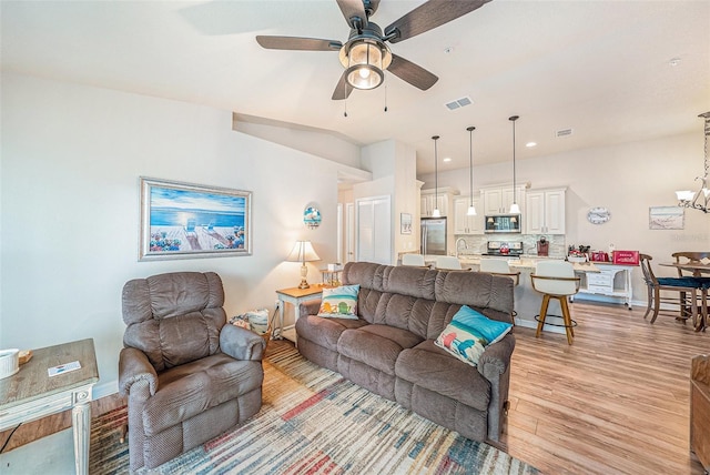5065 Royal Palms Way Unit 303, New Port Richey, FL 34652 - living area featuring light wood-style floors, a ceiling fan, a chandelier, and recessed lighting