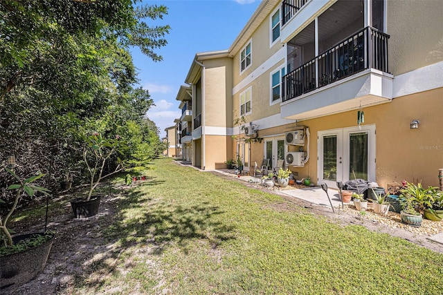 5065 Royal Palms Way Unit 303, New Port Richey, FL 34652 - view of green lawn featuring french doors and a patio