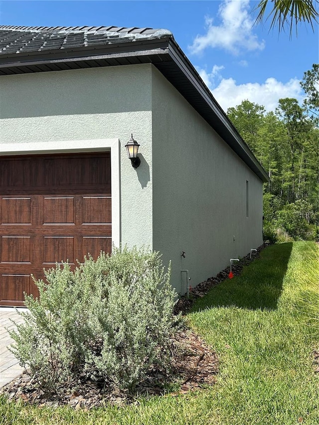 10864 Banyan Breeze Blvd, Land O Lakes, FL 34638 - view of property exterior featuring stucco siding and a lawn