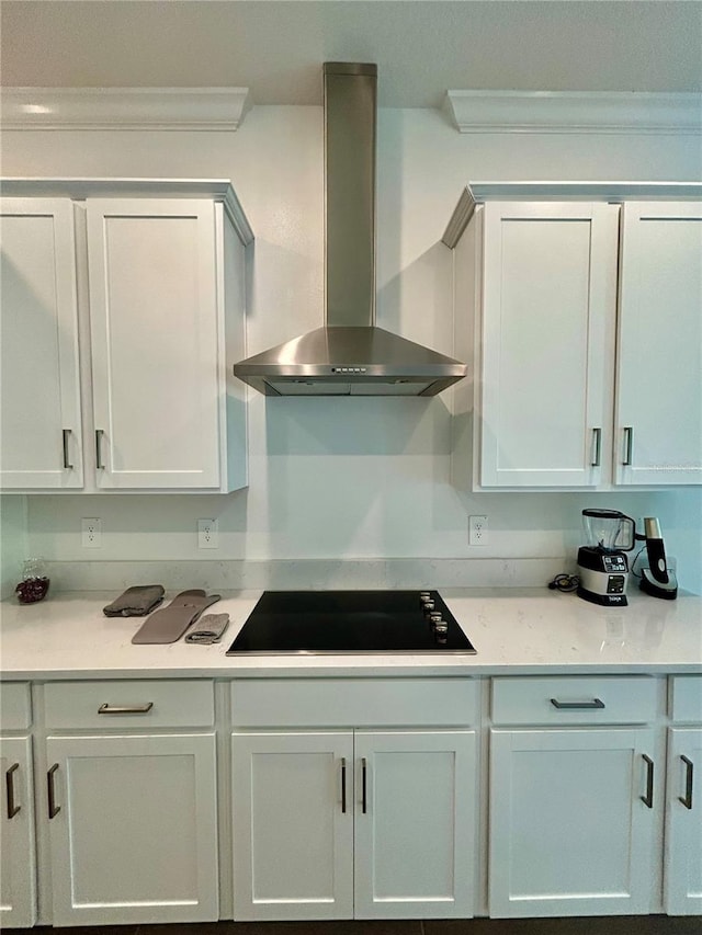 10864 Banyan Breeze Blvd, Land O Lakes, FL 34638 - kitchen with wall chimney range hood, black electric stovetop, light countertops, crown molding, and white cabinetry