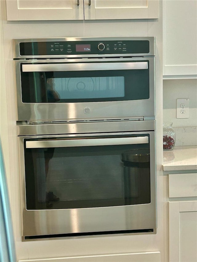 10864 Banyan Breeze Blvd, Land O Lakes, FL 34638 - kitchen view of double oven and white cabinets
