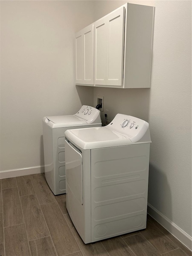 10864 Banyan Breeze Blvd, Land O Lakes, FL 34638 - laundry room with cabinet space, separate washer and dryer, and wood tiled floors