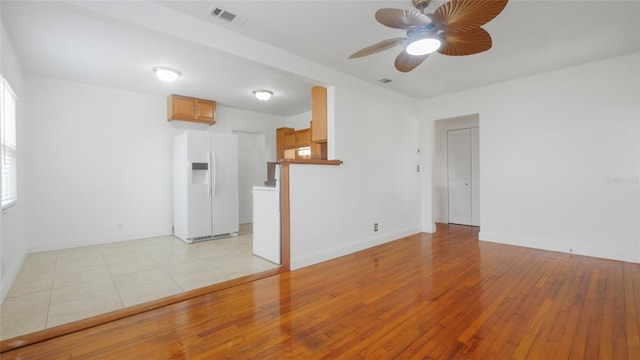 5725 18th Ave S, Gulfport, FL 33707 - unfurnished living room with light wood-style flooring and ceiling fan