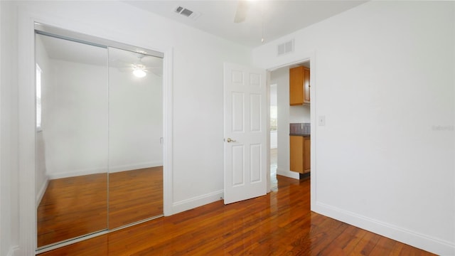 5725 18th Ave S, Gulfport, FL 33707 - unfurnished bedroom with hardwood / wood-style flooring, a closet, and a ceiling fan