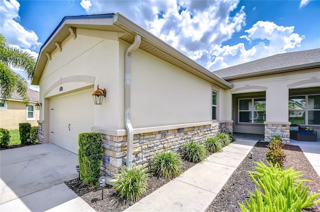 11619 Cambium Crown Dr, Riverview, FL 33569 - view of side of property with stone siding, stucco siding, and concrete driveway
