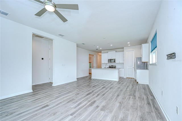 11619 Cambium Crown Dr, Riverview, FL 33569 - unfurnished living room featuring light wood finished floors, a ceiling fan, and recessed lighting