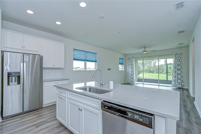 11619 Cambium Crown Dr, Riverview, FL 33569 - kitchen featuring appliances with stainless steel finishes, ceiling fan, an island with sink, white cabinetry, and recessed lighting