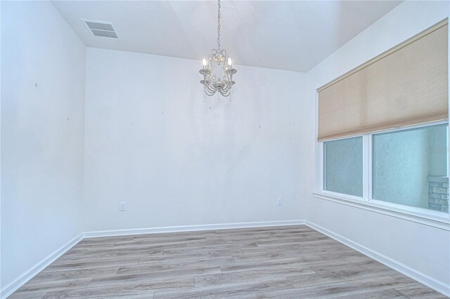 11619 Cambium Crown Dr, Riverview, FL 33569 - empty room featuring a chandelier and light wood-style flooring