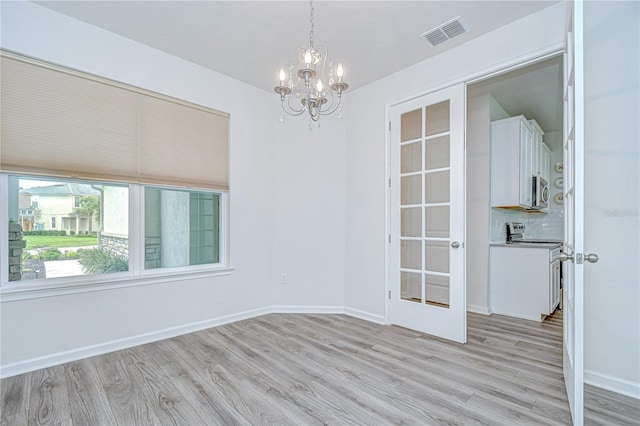 11619 Cambium Crown Dr, Riverview, FL 33569 - empty room featuring a chandelier and light wood-style floors