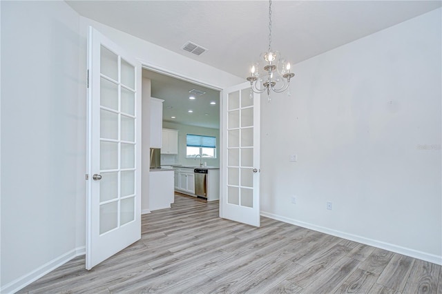 11619 Cambium Crown Dr, Riverview, FL 33569 - spare room with french doors, light wood-type flooring, a chandelier, and recessed lighting