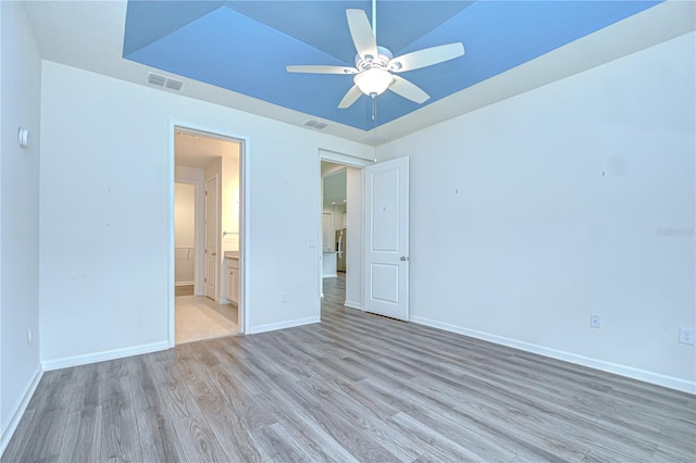 11619 Cambium Crown Dr, Riverview, FL 33569 - unfurnished bedroom with light wood-style flooring, connected bathroom, and a ceiling fan