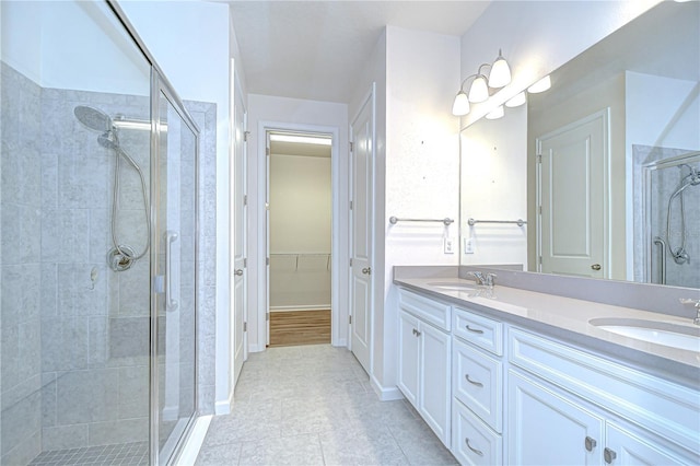 11619 Cambium Crown Dr, Riverview, FL 33569 - bathroom with a shower stall, double vanity, a spacious closet, and tile patterned flooring