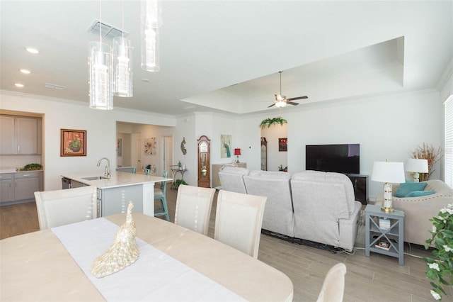 11717 74th Cir E, Palmetto, FL 34221 - dining space featuring light wood-style flooring, ornamental molding, a ceiling fan, a raised ceiling, and recessed lighting