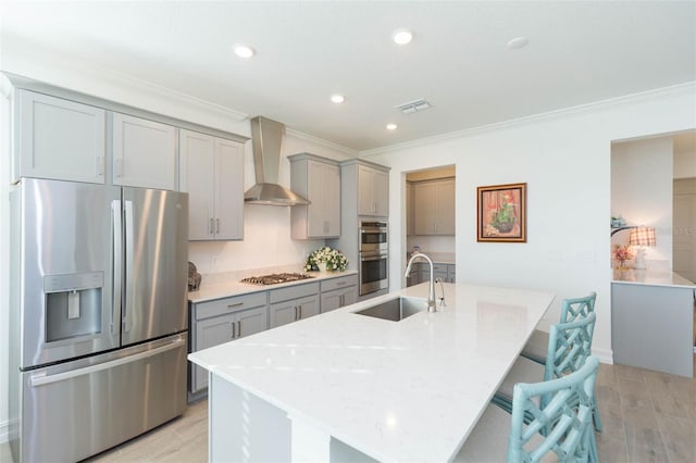 11717 74th Cir E, Palmetto, FL 34221 - kitchen featuring stainless steel appliances, gray cabinets, wall chimney range hood, ornamental molding, and light wood finished floors
