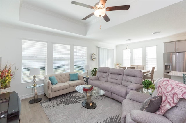 11717 74th Cir E, Palmetto, FL 34221 - living area featuring a raised ceiling, wood finished floors, a ceiling fan, and crown molding