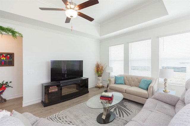 11717 74th Cir E, Palmetto, FL 34221 - living room with a raised ceiling, light wood-type flooring, a ceiling fan, and crown molding