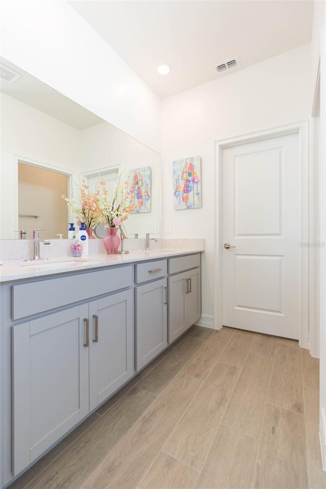 11717 74th Cir E, Palmetto, FL 34221 - full bathroom featuring double vanity, wood finished floors, and recessed lighting