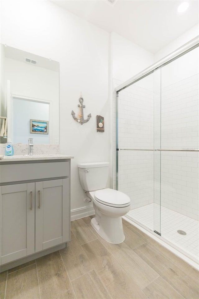 11717 74th Cir E, Palmetto, FL 34221 - bathroom with vanity, wood finish floors, and a stall shower
