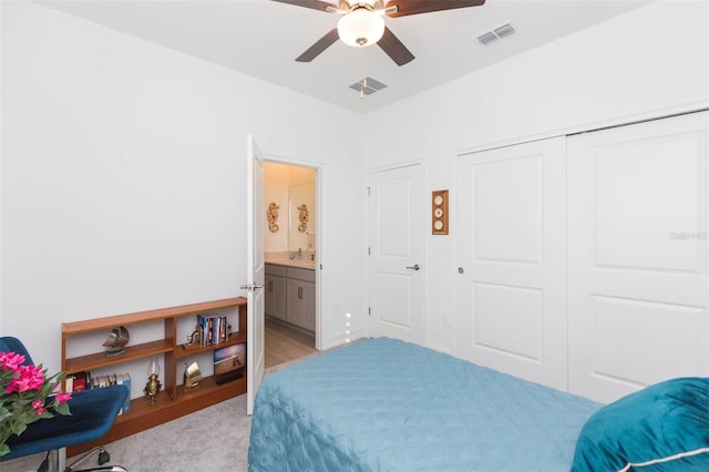 11717 74th Cir E, Palmetto, FL 34221 - bedroom featuring a closet, light carpet, ceiling fan, and ensuite bathroom