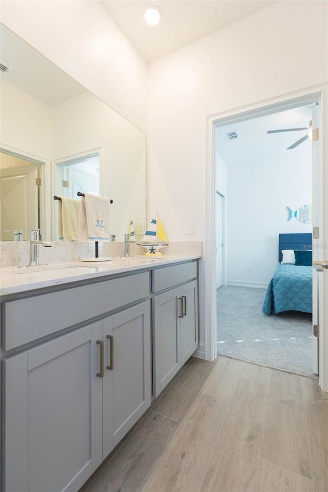 11717 74th Cir E, Palmetto, FL 34221 - full bath featuring wood finished floors, double vanity, and ensuite bathroom