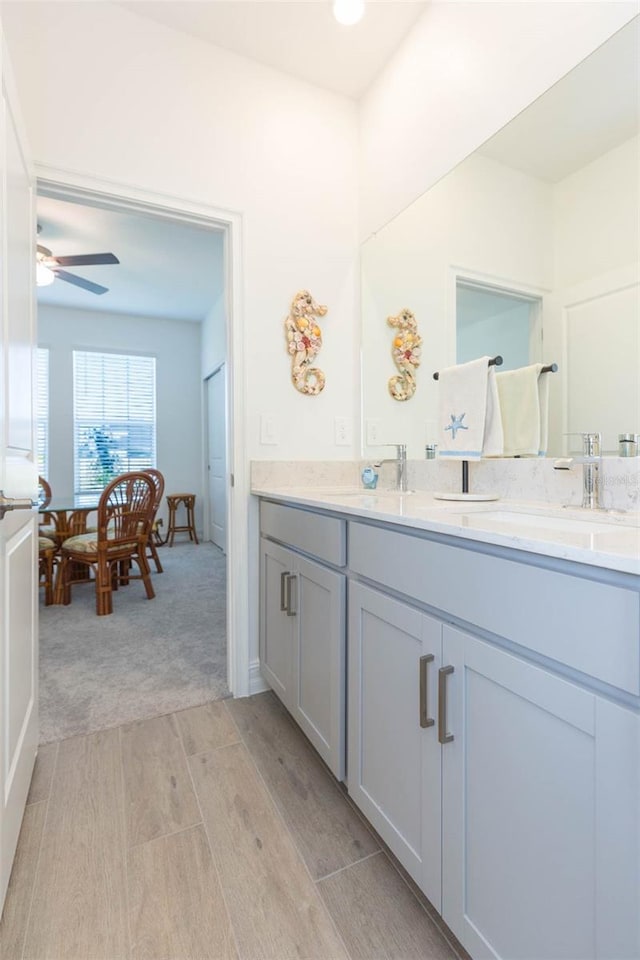 11717 74th Cir E, Palmetto, FL 34221 - bathroom with double vanity, wood finished floors, and ceiling fan