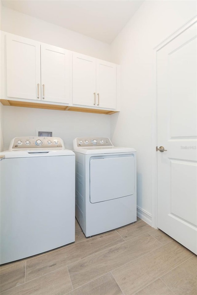 11717 74th Cir E, Palmetto, FL 34221 - laundry room with cabinet space, washer and dryer, and light wood finished floors