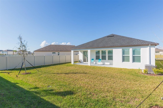 11717 74th Cir E, Palmetto, FL 34221 - rear view of house with a fenced backyard, a patio, stucco siding, and a shingled roof