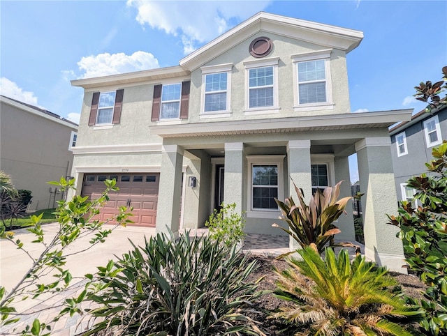 32599 Natural Bridge Rd, Wesley Chapel, FL 33543 - view of front of property with a porch, stucco siding, an attached garage, and driveway