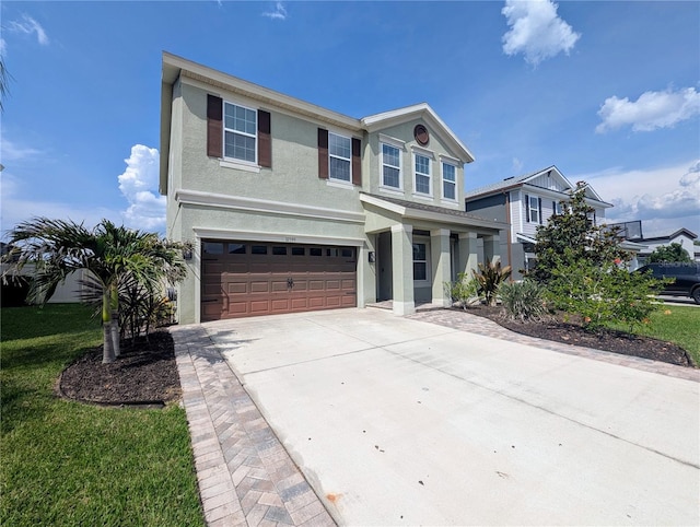 32599 Natural Bridge Rd, Wesley Chapel, FL 33543 - view of front of house with an attached garage, concrete driveway, and stucco siding