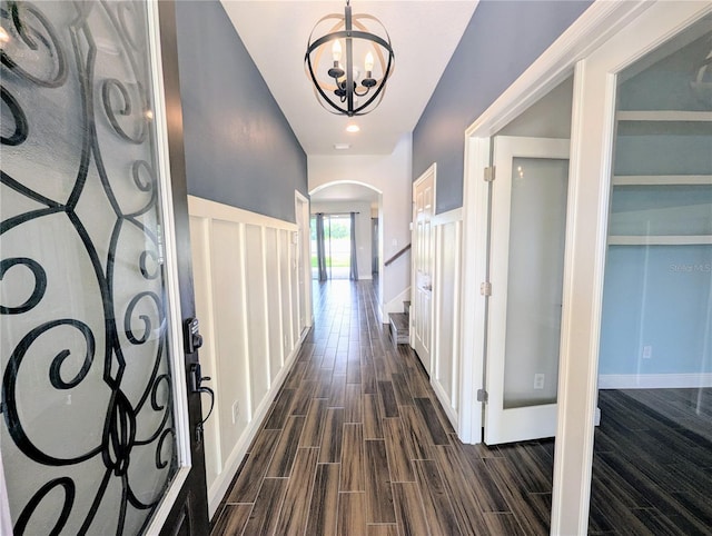 32599 Natural Bridge Rd, Wesley Chapel, FL 33543 - corridor with arched walkways, a chandelier, and dark wood-style floors