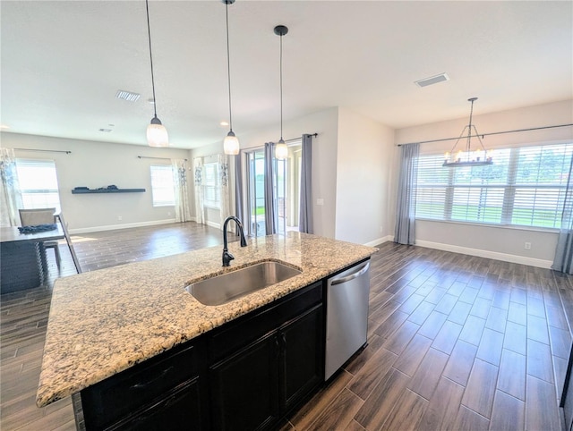 32599 Natural Bridge Rd, Wesley Chapel, FL 33543 - kitchen featuring stainless steel dishwasher, dark cabinetry, open floor plan, and dark wood-type flooring