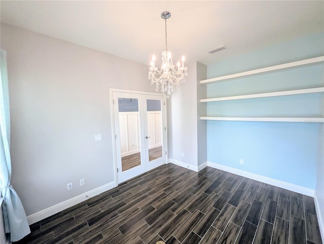 32599 Natural Bridge Rd, Wesley Chapel, FL 33543 - unfurnished dining area with french doors, dark wood-style flooring, and a chandelier