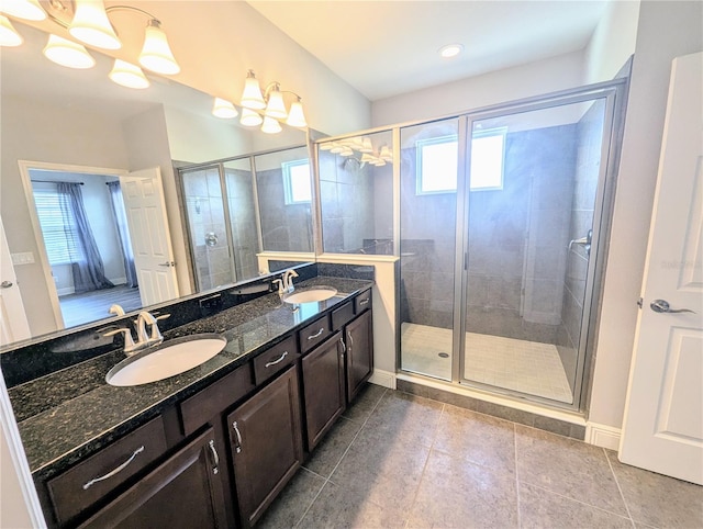 32599 Natural Bridge Rd, Wesley Chapel, FL 33543 - full bathroom with double vanity, a shower stall, tile patterned floors, and a chandelier