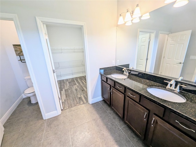 32599 Natural Bridge Rd, Wesley Chapel, FL 33543 - full bath featuring double vanity, a spacious closet, tile patterned flooring, and a chandelier