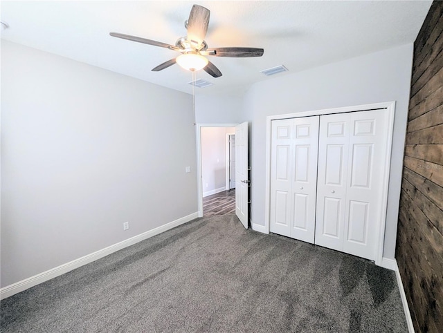 32599 Natural Bridge Rd, Wesley Chapel, FL 33543 - unfurnished bedroom featuring dark colored carpet, a closet, and ceiling fan