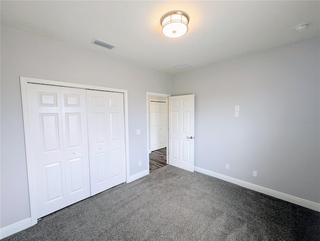 32599 Natural Bridge Rd, Wesley Chapel, FL 33543 - unfurnished bedroom featuring dark carpet and a closet
