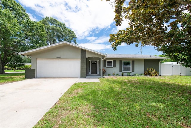 1461 S Hillcrest Ave, Clearwater, FL 33756 - ranch-style home featuring a garage, a front yard, stucco siding, and concrete driveway