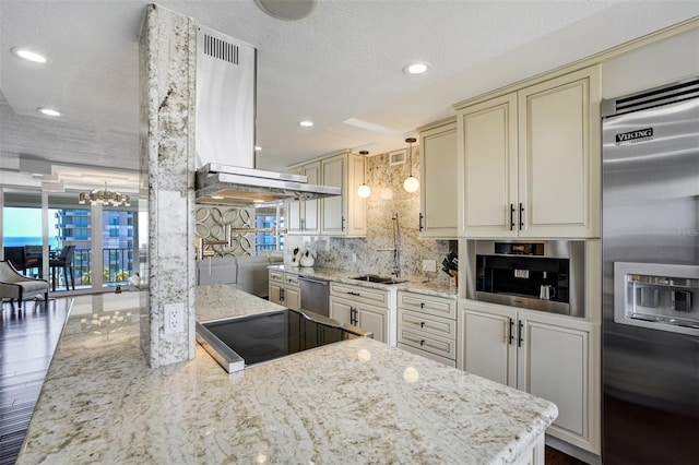 1581 Gulf Blvd Unit 701N, Clearwater Beach, FL 33767 - kitchen featuring stainless steel appliances, cream cabinetry, a chandelier, tasteful backsplash, and recessed lighting